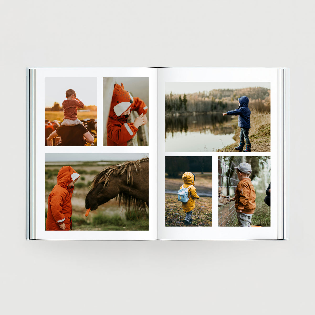 Open children’s personalised photo book with outdoor family photos and printed page layouts.